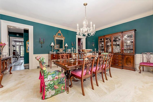 carpeted dining space featuring ornamental molding and a notable chandelier