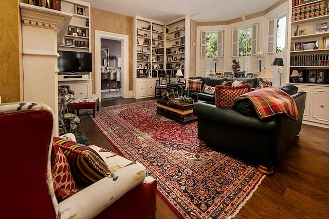 living room with built in features and dark wood-type flooring