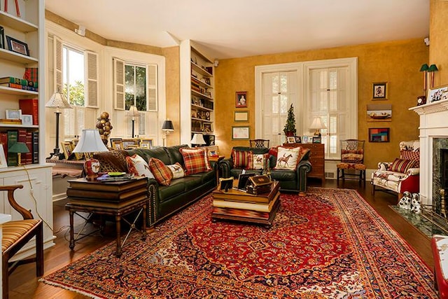 living room featuring built in features and dark hardwood / wood-style floors