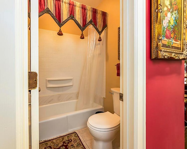 bathroom featuring tile flooring, toilet, and shower / bathtub combination with curtain