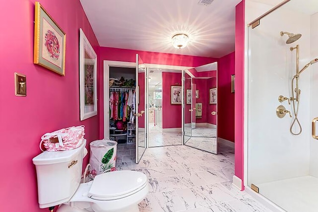 bathroom featuring walk in shower, tile floors, and toilet