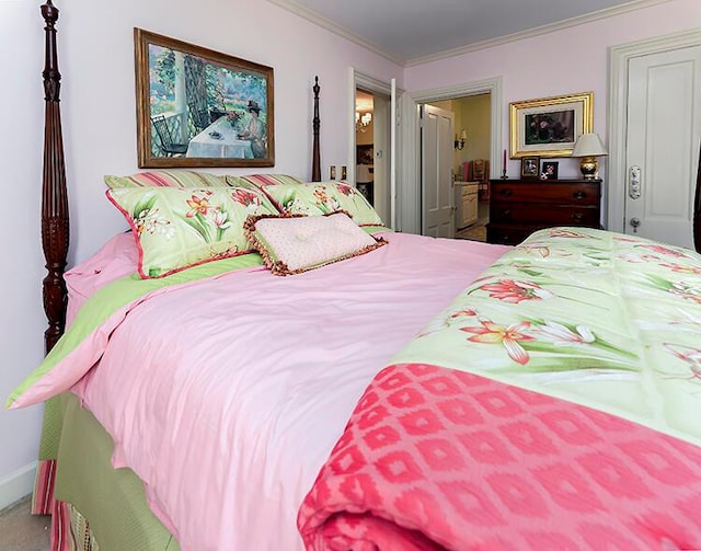 bedroom with carpet flooring and crown molding