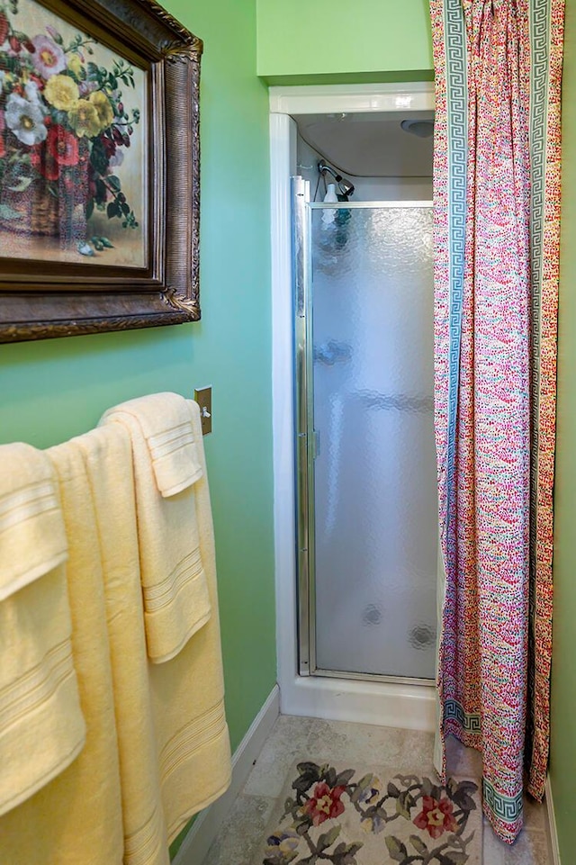 bathroom featuring tile floors and a shower with door