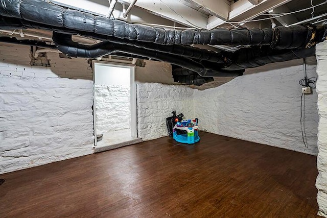 basement featuring dark wood-type flooring