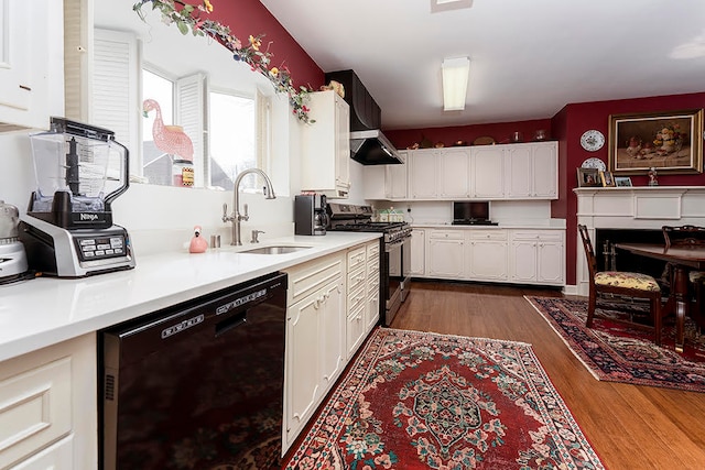 kitchen with dark hardwood / wood-style flooring, black dishwasher, white cabinets, gas range, and sink