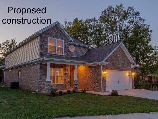 craftsman-style house with a front yard, a garage, and central air condition unit