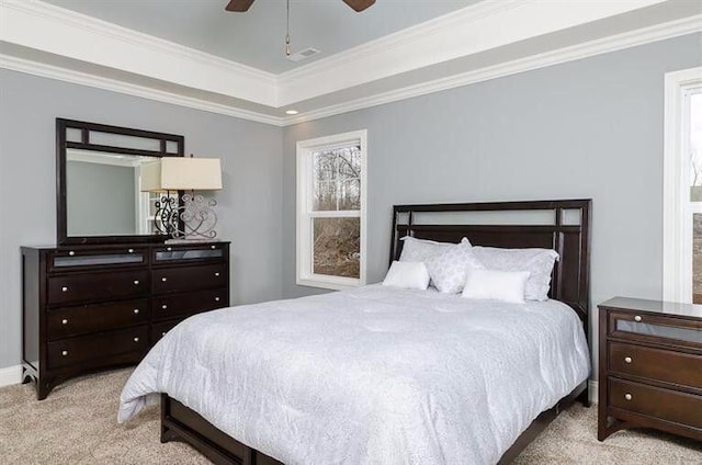 bedroom featuring ceiling fan, crown molding, and light colored carpet