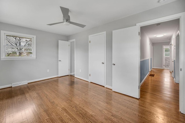 unfurnished room featuring ceiling fan and hardwood / wood-style flooring