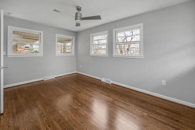 spare room featuring dark hardwood / wood-style floors and ceiling fan