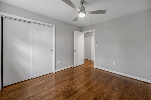 unfurnished bedroom with a closet, ceiling fan, and dark hardwood / wood-style flooring