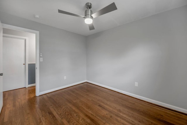 empty room featuring ceiling fan and dark wood-type flooring