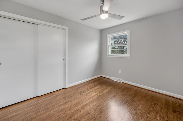 unfurnished bedroom featuring a closet, ceiling fan, and light wood-type flooring