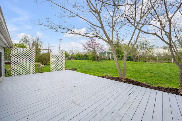 wooden terrace featuring a yard