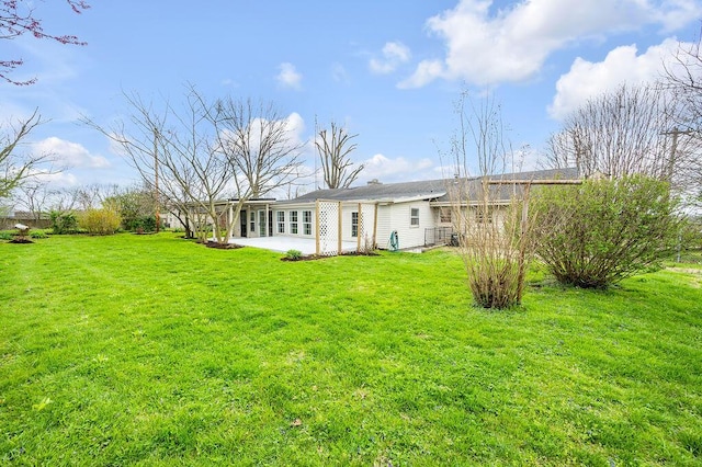 rear view of house featuring a lawn