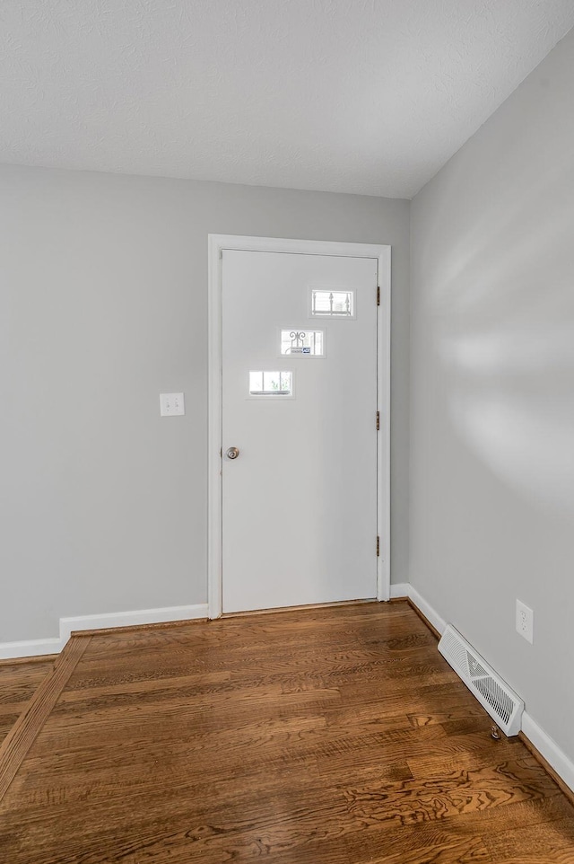 foyer entrance featuring dark hardwood / wood-style flooring