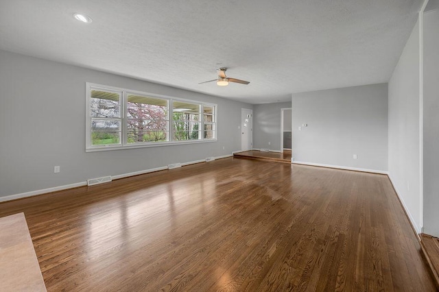 spare room with ceiling fan and dark wood-type flooring