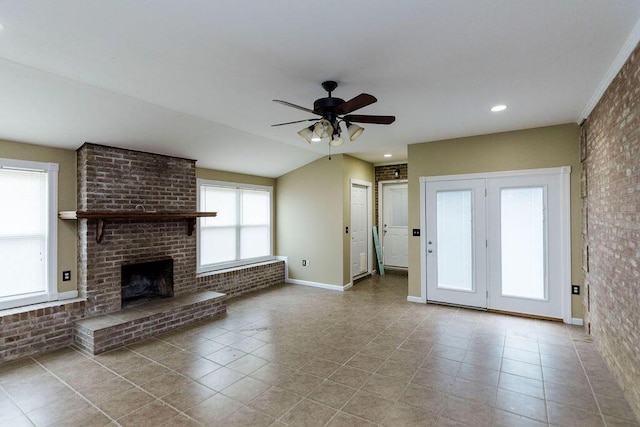 unfurnished living room featuring brick wall, light tile floors, a brick fireplace, and ceiling fan