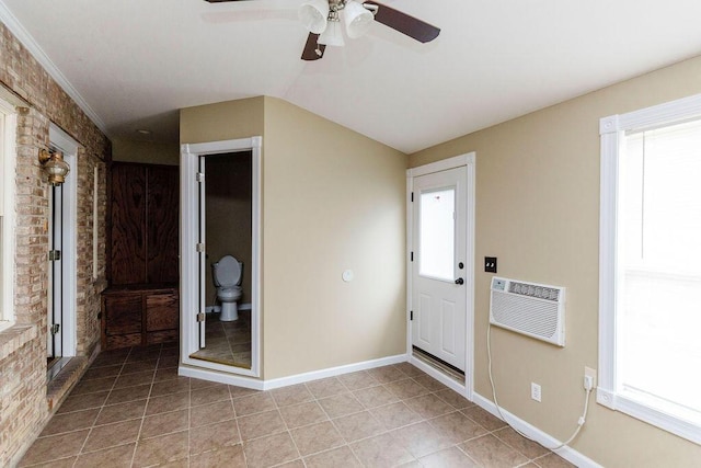 tiled foyer with ceiling fan, brick wall, and a healthy amount of sunlight