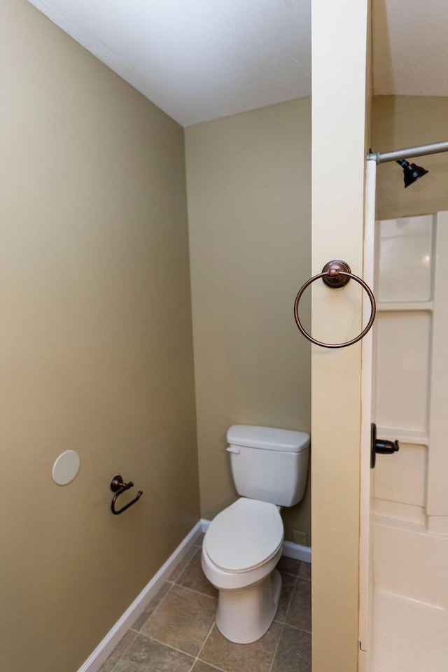 bathroom featuring toilet and tile floors