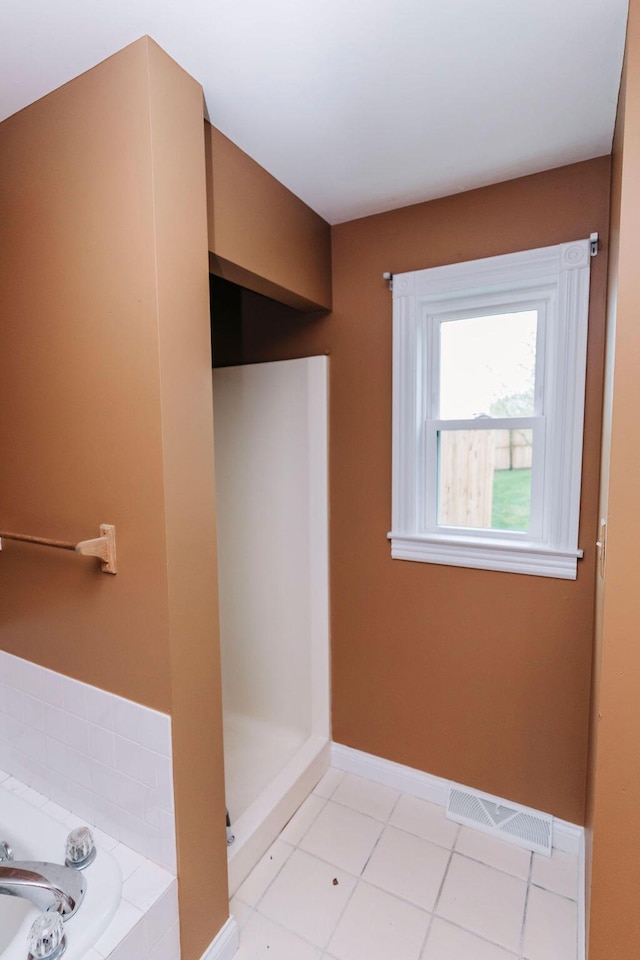 bathroom featuring a bathing tub and tile floors