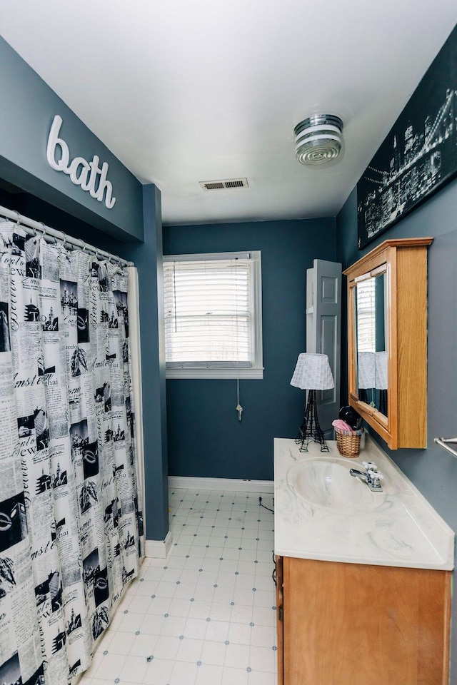 bathroom with tile flooring and vanity