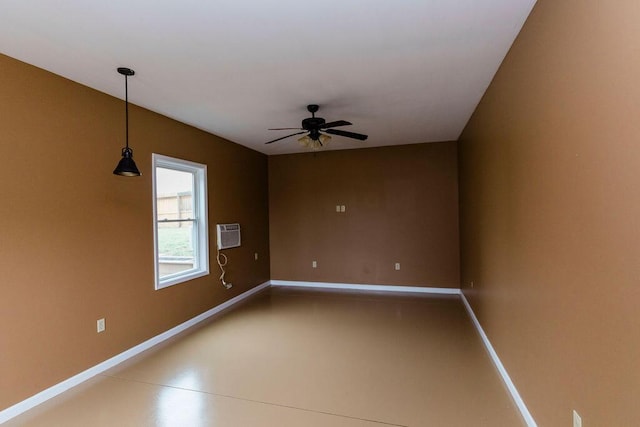 spare room featuring ceiling fan and a wall mounted air conditioner