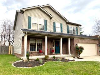 view of front of home with a porch and a front yard