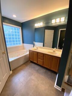 bathroom featuring vanity and a bath