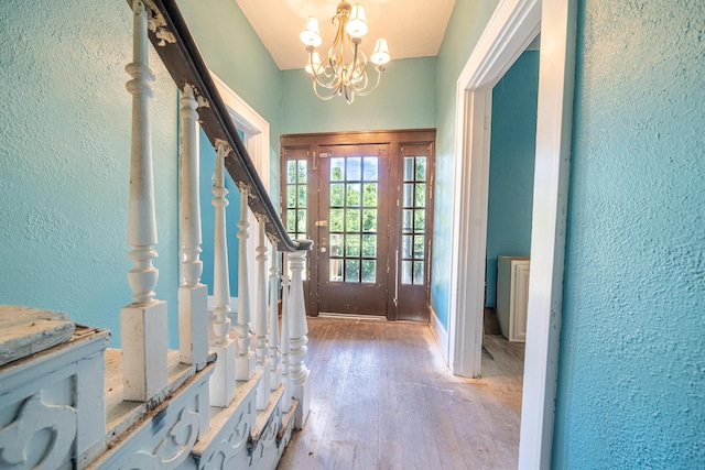 entryway with a notable chandelier and light wood-type flooring