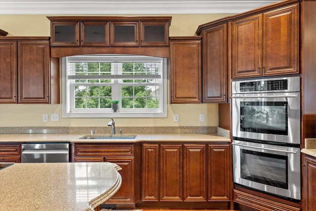 kitchen featuring sink, appliances with stainless steel finishes, and ornamental molding