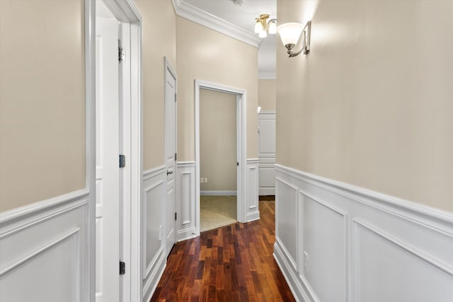 hall with dark wood-type flooring and crown molding