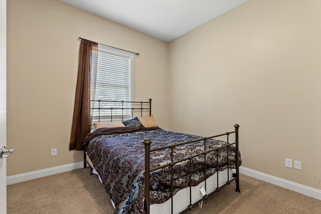 bedroom featuring light carpet