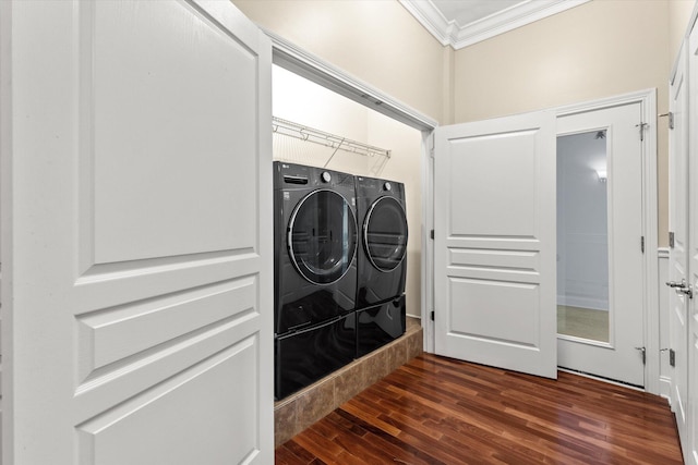 clothes washing area with dark hardwood / wood-style floors, washing machine and dryer, and crown molding