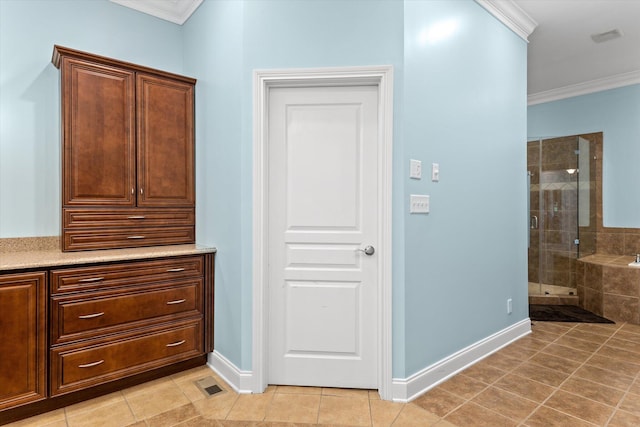 bathroom featuring tile patterned flooring, crown molding, shower with separate bathtub, and vanity