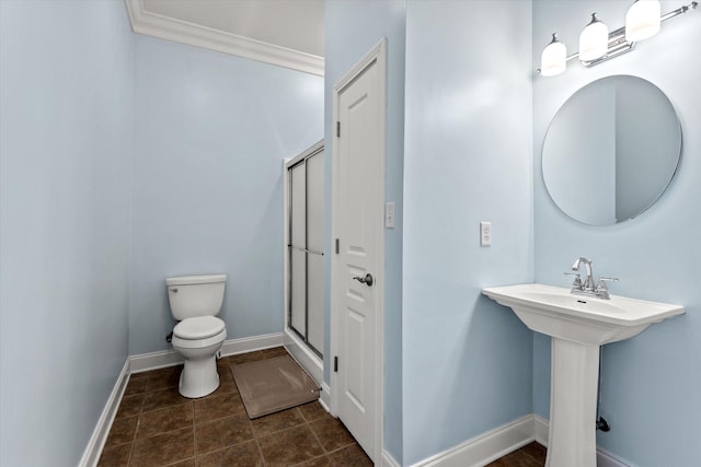 bathroom with tile patterned flooring, toilet, crown molding, and walk in shower