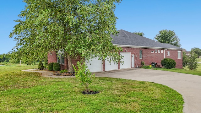 view of property hidden behind natural elements featuring a garage and a front yard