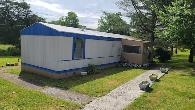 view of side of home featuring a yard