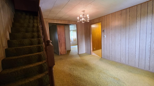 interior space featuring an inviting chandelier and wood walls