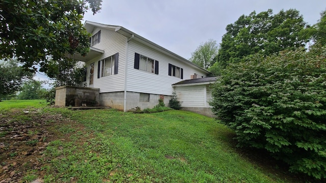 view of property exterior with a lawn