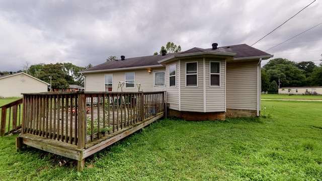 back of house with a wooden deck and a lawn