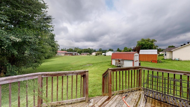 wooden deck featuring a lawn and a shed