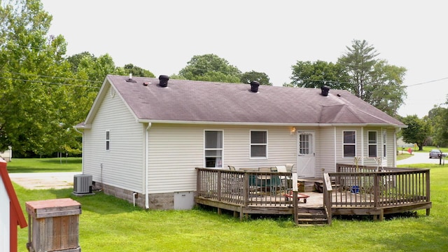 back of property featuring a lawn, central air condition unit, and a wooden deck