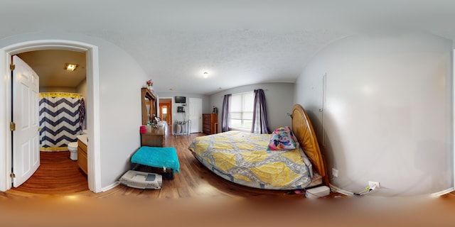 bedroom with a textured ceiling and ensuite bathroom