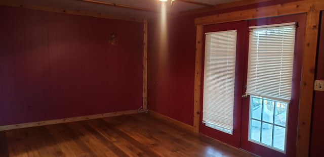 spare room featuring french doors, dark hardwood / wood-style floors, and ceiling fan