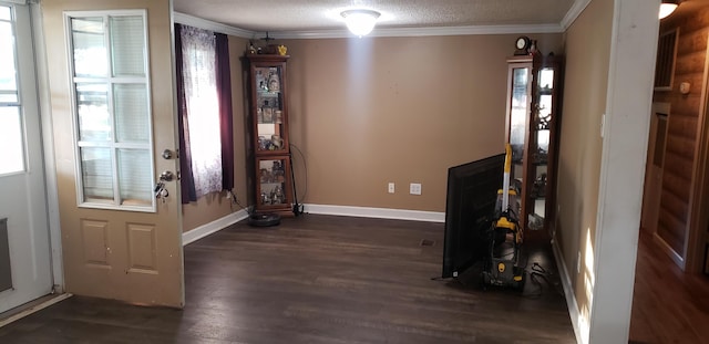 foyer featuring crown molding, a textured ceiling, and dark wood-type flooring