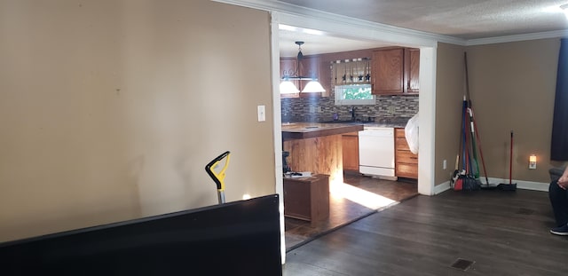 kitchen with white dishwasher, decorative light fixtures, tasteful backsplash, ornamental molding, and dark hardwood / wood-style flooring