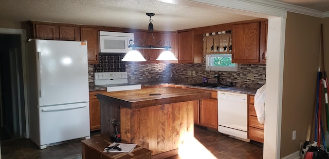 kitchen featuring decorative light fixtures, tasteful backsplash, white appliances, dark tile floors, and sink