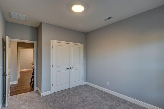 unfurnished bedroom featuring a closet and light wood-type flooring