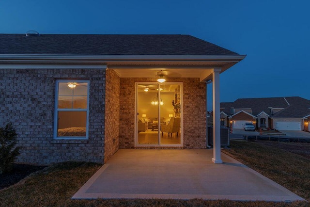 exterior entry at twilight featuring a patio area