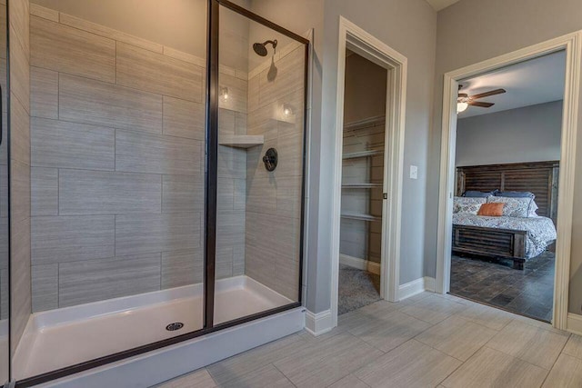 bathroom featuring tile floors, ceiling fan, and walk in shower